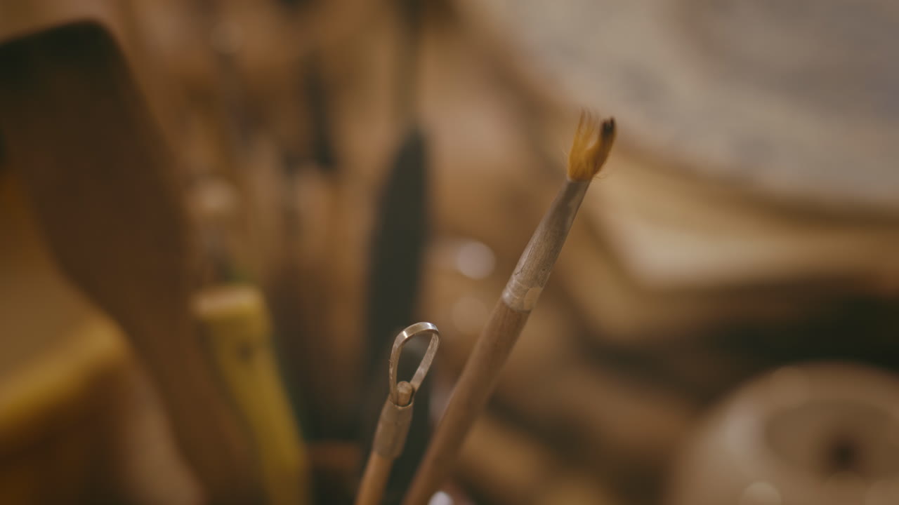 Close-up of pottery tools and brush
