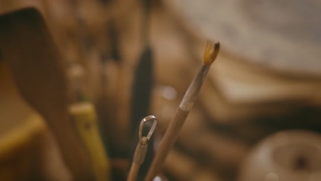 close-up of pottery tools and brush