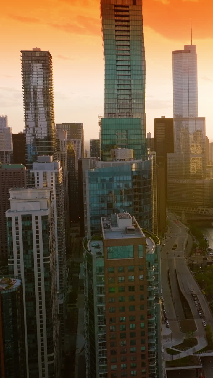 Unbelievable scenery of amazing metropolis at sunset. Beautiful Chicago skyscrapers at the backdrop of orange sky. Vertical video