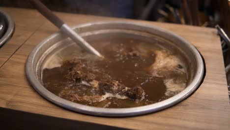 a close-up of a traditional thai meat stew simmering in bangkok, thailand