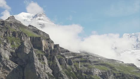 a stunning diagonal pan shot of an ice capped mountain in the swiss alps, switzerland