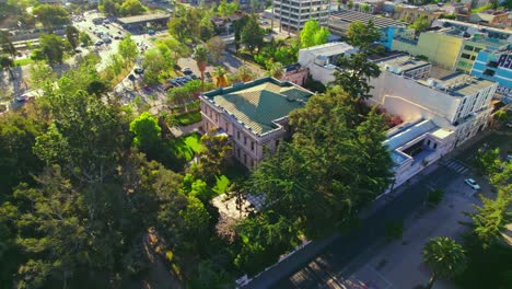 Aerial-orbit-establishing-the-Cousiño-Palace-and-its-garden-of-endemic-species-of-Chile,-deciocho-neighborhood,-Santiago-Chile