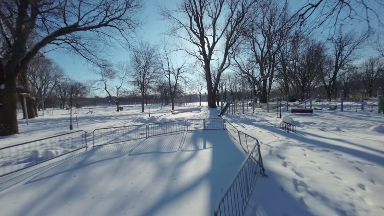 Drone Fpv shot across various obstacles rides in a playground during winter