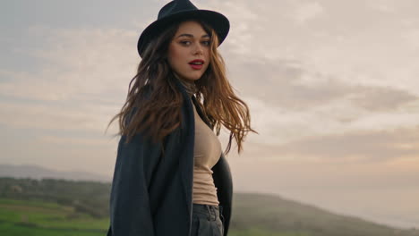 Active-girl-wanderer-walking-green-valley-in-stylish-hat-close-up.-Pretty-model.