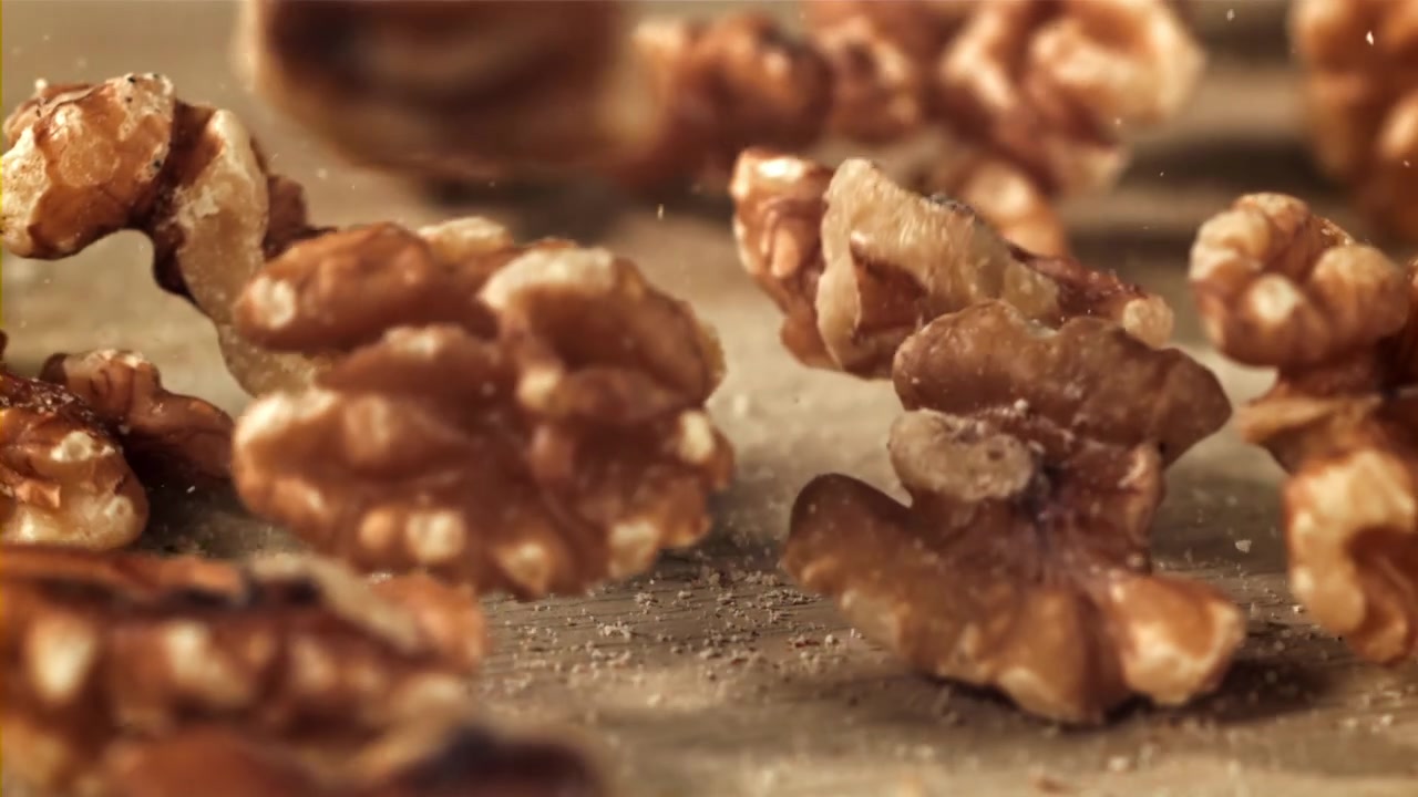 Walnuts Falling onto a Wooden Surface in Slow Motion