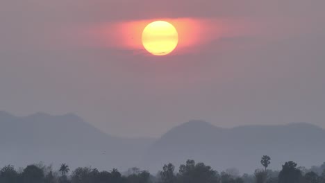 scene nature beautiful big sunset on sky in the evening. background red sunset full and mountain, forest