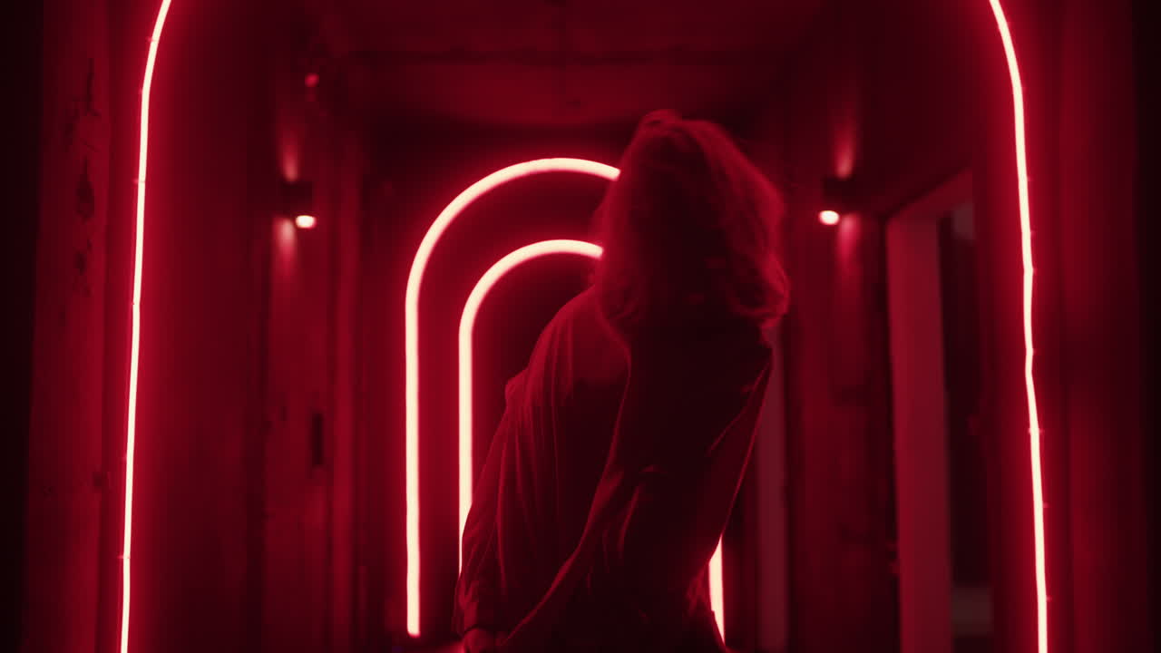 Woman in Neon Red Corridor