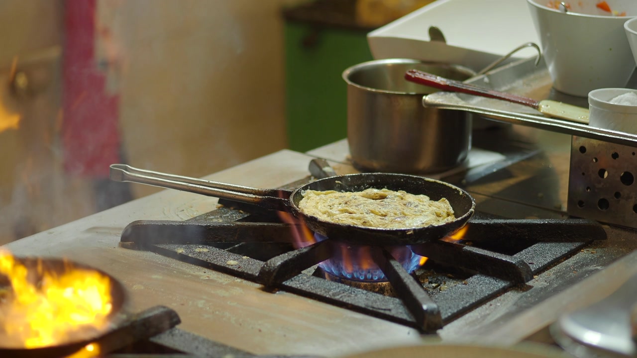Chef Cooking and Flambéing Food in a Frying Pan