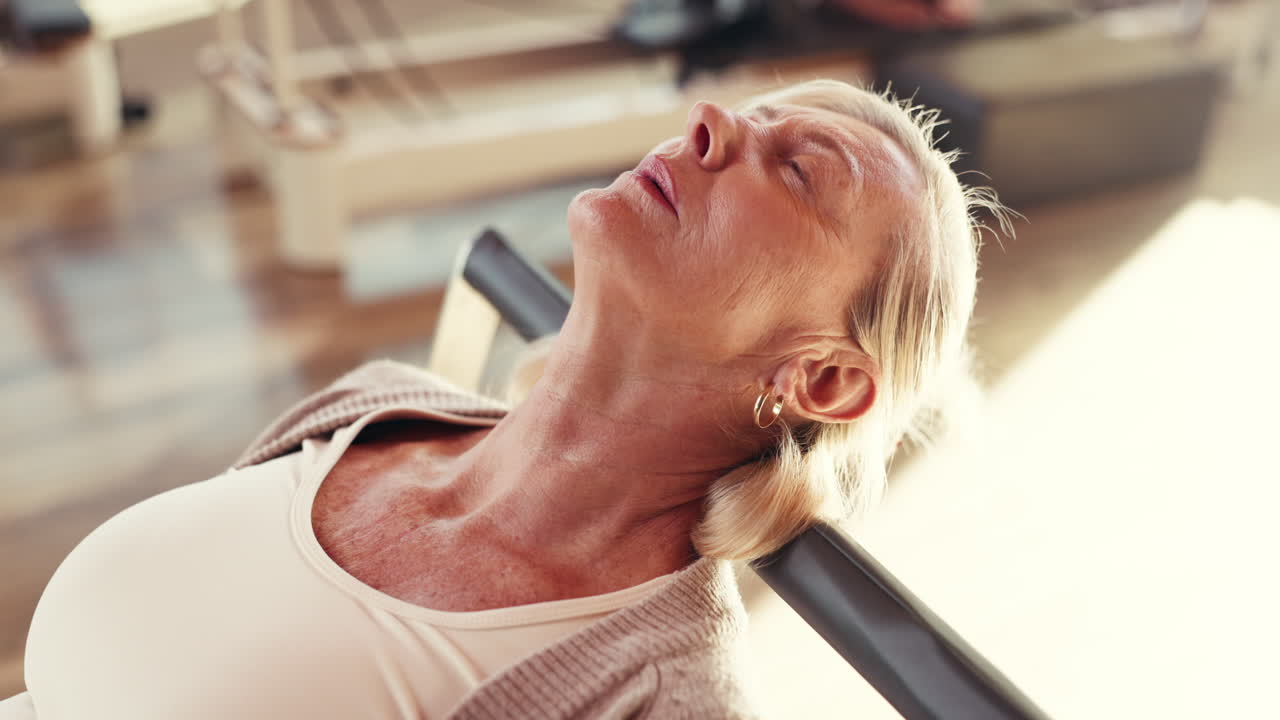 Senior Woman Relaxing During Pilates Session