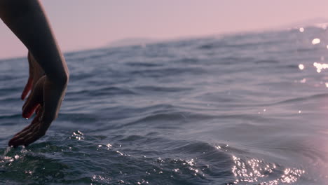 close up woman hand touching water waves splashing tourist enjoying boat ride