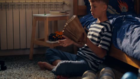 boy holding a baseball glove in his bedroom