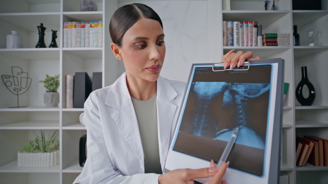 Radiology expert analyzing x-ray at tablet showing in webcam pov video at clinic