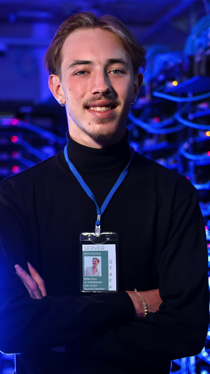 Man standing in a server room. Vertical