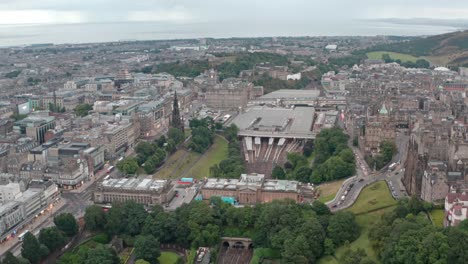 Dolly-forward-drone-shot-over-Edinburgh-Waverly-towards-prince-street-Calton-hill
