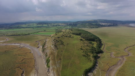 Aerial-view-of-a-hill-formation-on-the-west-coast-of-England,-on-a-bright-day