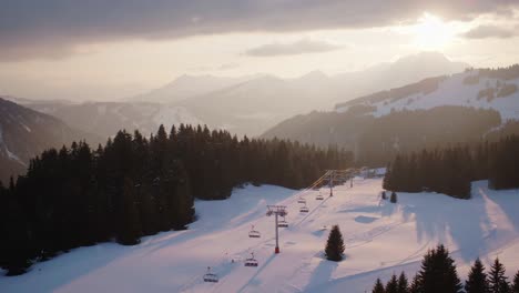 a chairlift in the french alps at sunset