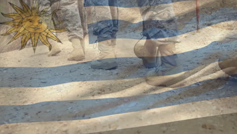 Marching military boots over Uruguay flag with sun emblem in animation