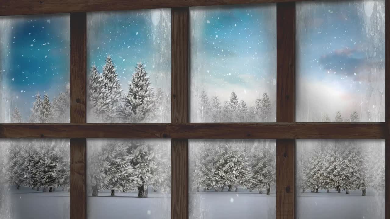 Wooden window frame against snow falling over multiple trees on winter landscape