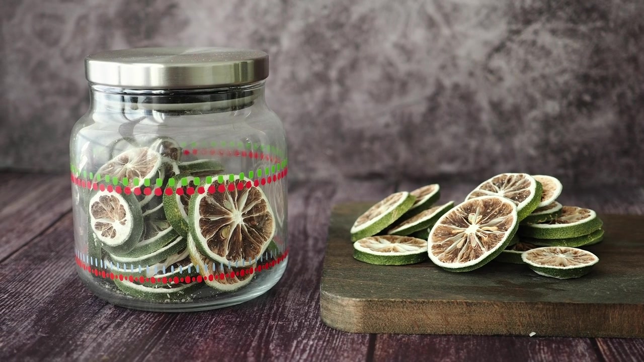 Dried Lime Slices in Glass Jar and on Wooden Board