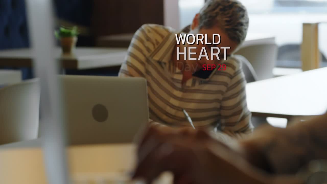 World heart day text banner against caucasian woman talking notes while talking on smartphone