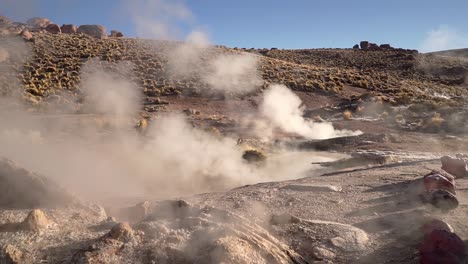 el tatio geysers steaming in the atacama desert in chile, south america