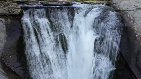 aerial-push-in-to-elk-river-falls,-water-gushes-from-river-in-elk-park-nc,-north-carolina-not-far-from-beech-mountain-and-sugar-mountain-nc,-banner-elk-nc,-bristol-tennessee,-elizabethton-tennessee