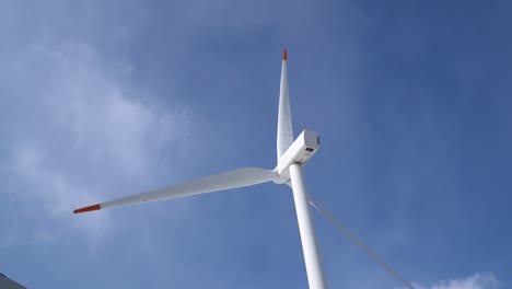 closeup of single wind power turbine on blue sky background in pyeongchang, south korea