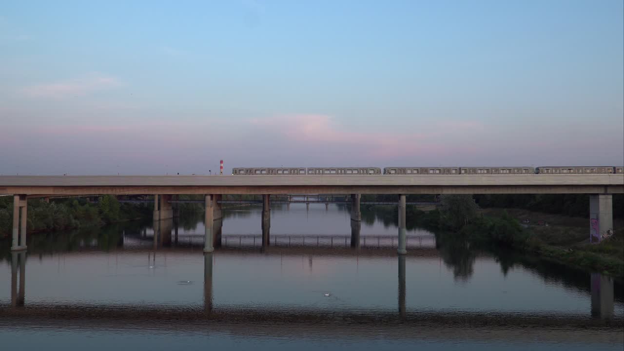 Train Passing On The Railway Bridge Over The Danube River On Donauinsel In Vienna, Austria - Wide Shot