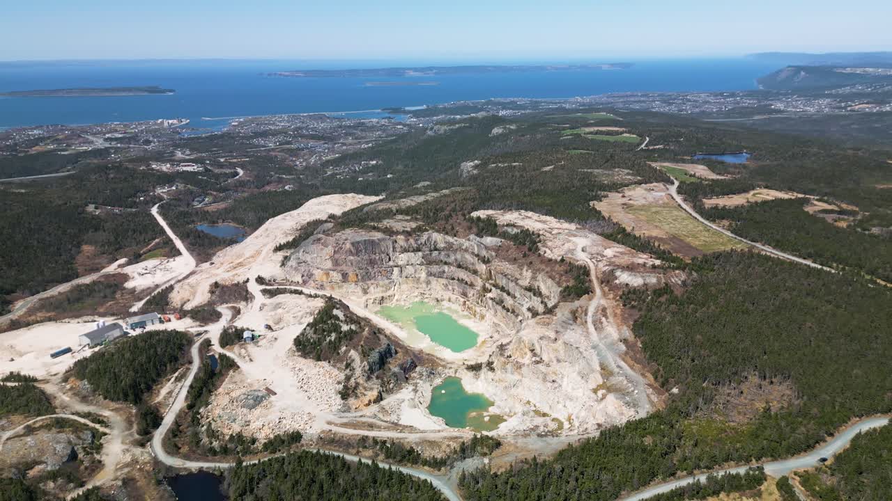 Drone shot of an open talc (Pyrophillite) mine in Manuels, Newfoundland Canada displaying Conception Bay South in the background