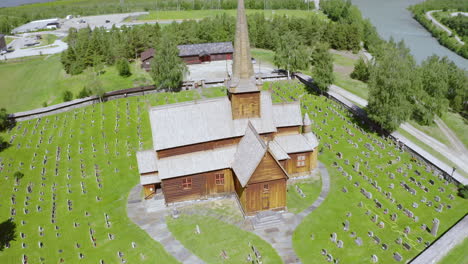 lom stave church with gravestone near bovra and otta river in lom, norway