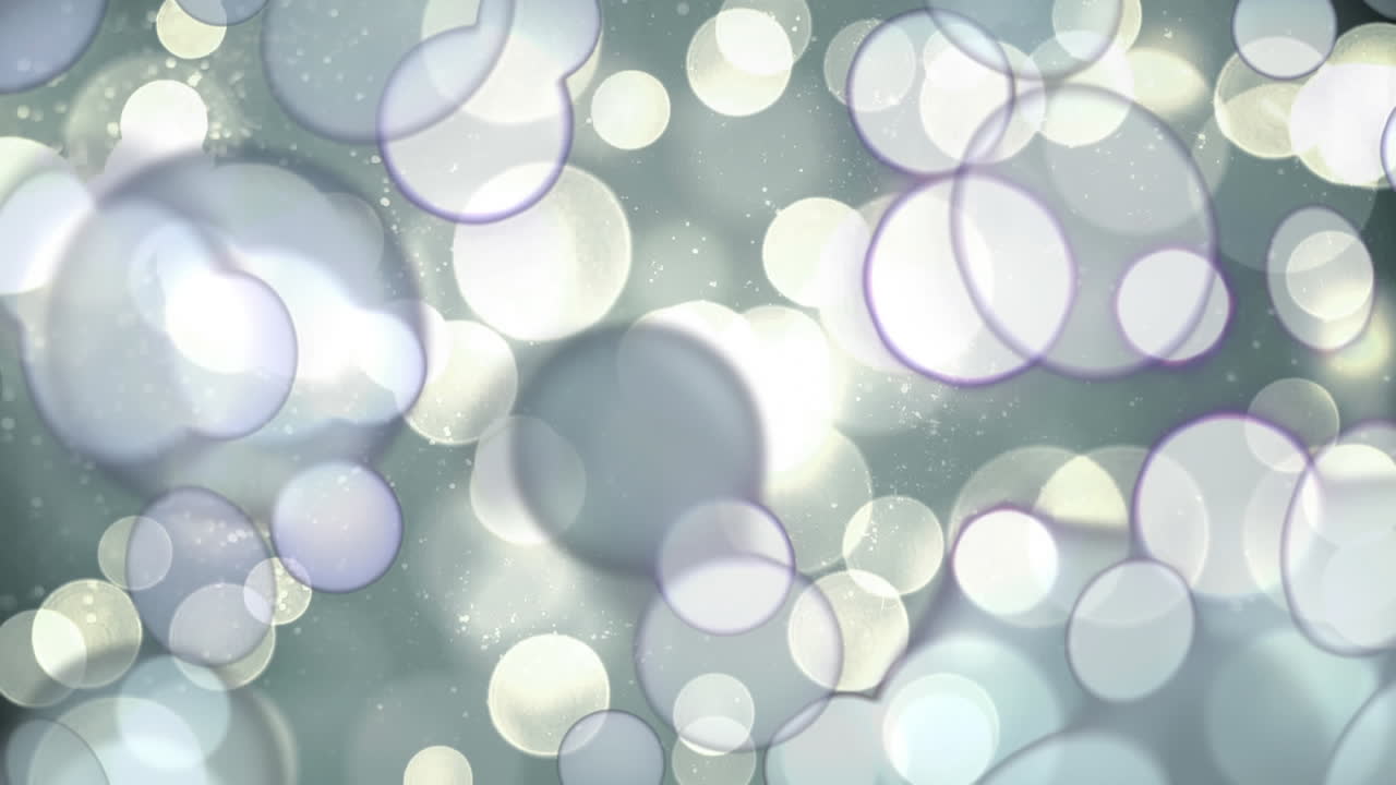 회색 배경에 움직이는 반이는 빛의 반점의 디지털 애니메이션