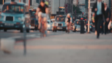 anonymous crowd of people walking cycling bicycles commuters london city street slow motion