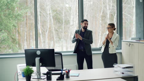 business team celebrating in office