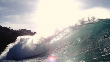 sunlit wave breaks slowly with glowing textures and scenic backdrop