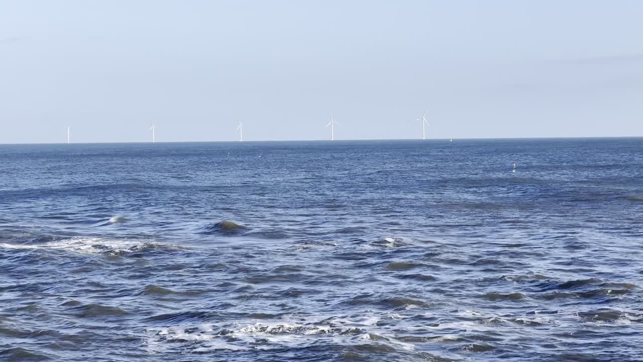 Wind turbines in the distance in the North Sea - taken off the North East Coastline at Whitley Bay (North Tyneside, UK)