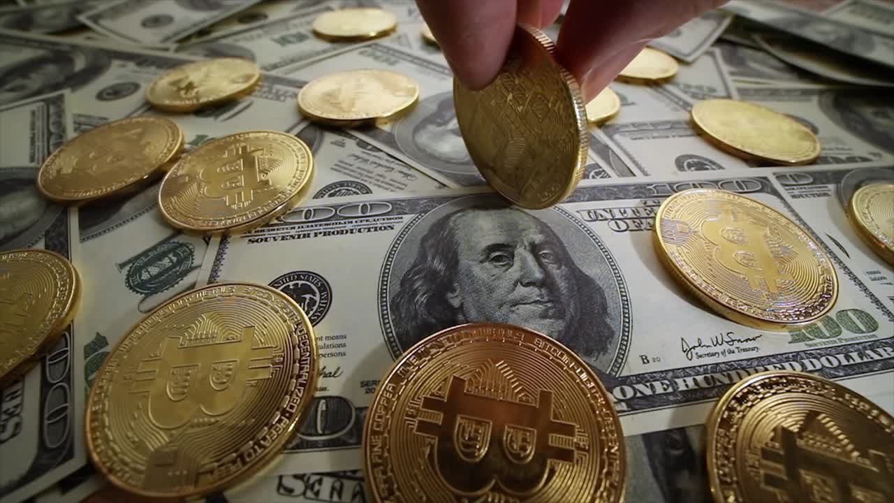 Gold Bit Coin BTC coins and dollar bills.
