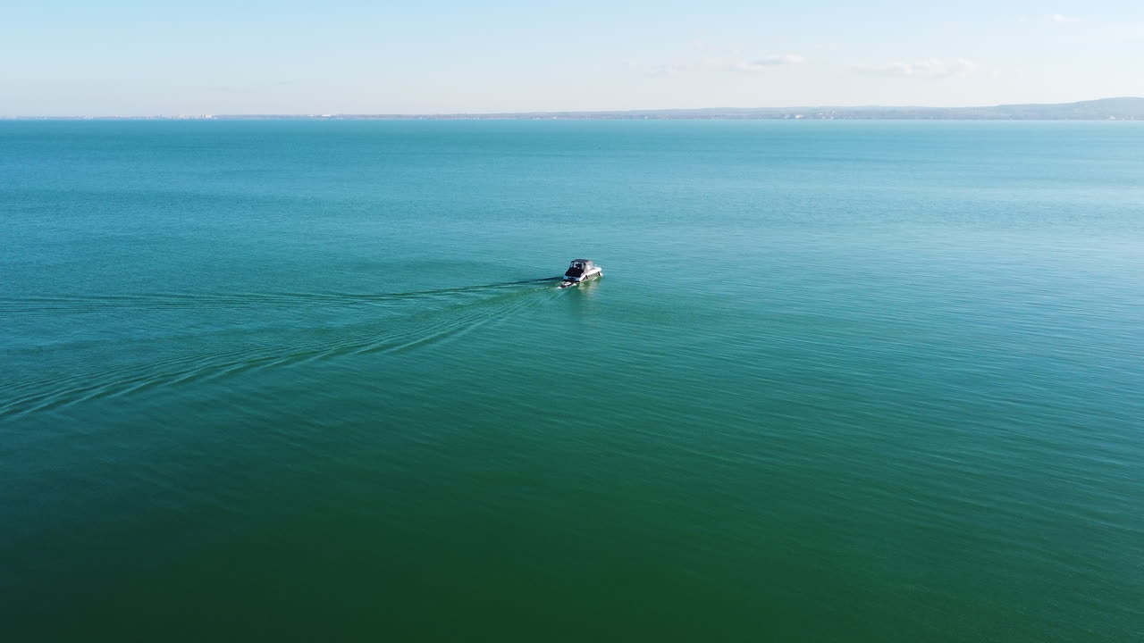 Drone view of Kis Mohle pier in open water near horizon with faint landscape in background