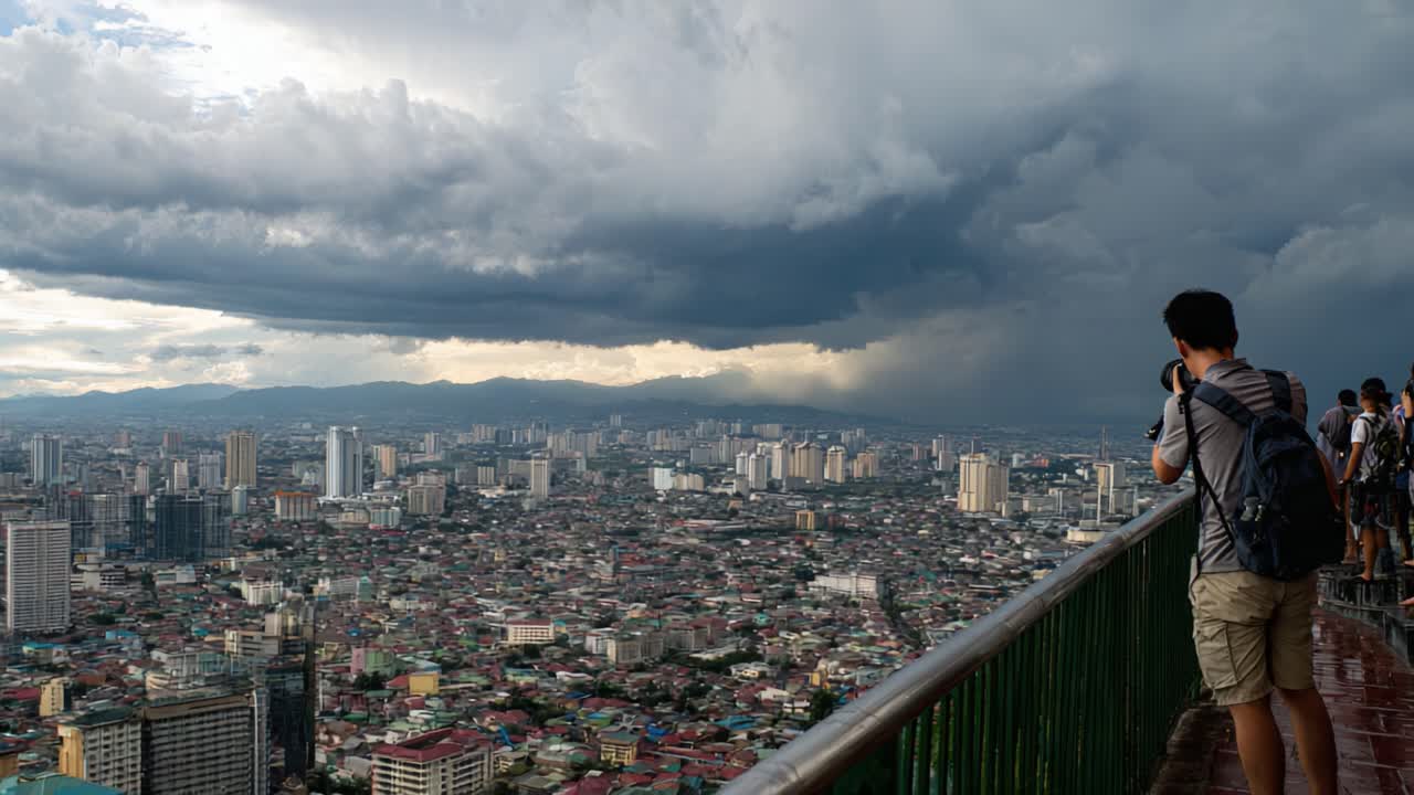A Breathtaking Overhead View of a Bustling Cityscape Under Dramatic Clouds Captured by a Photographer at a High Observation Point