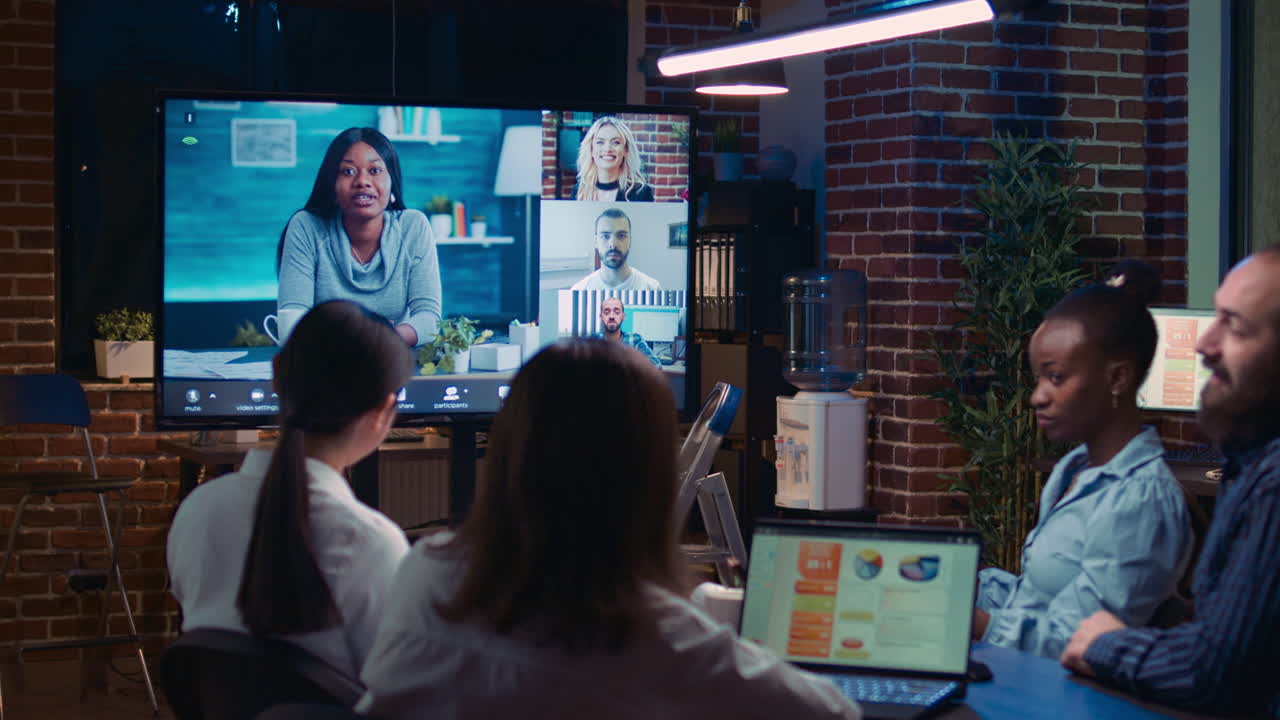 Remote team discussing analytics report in business meeting videocall