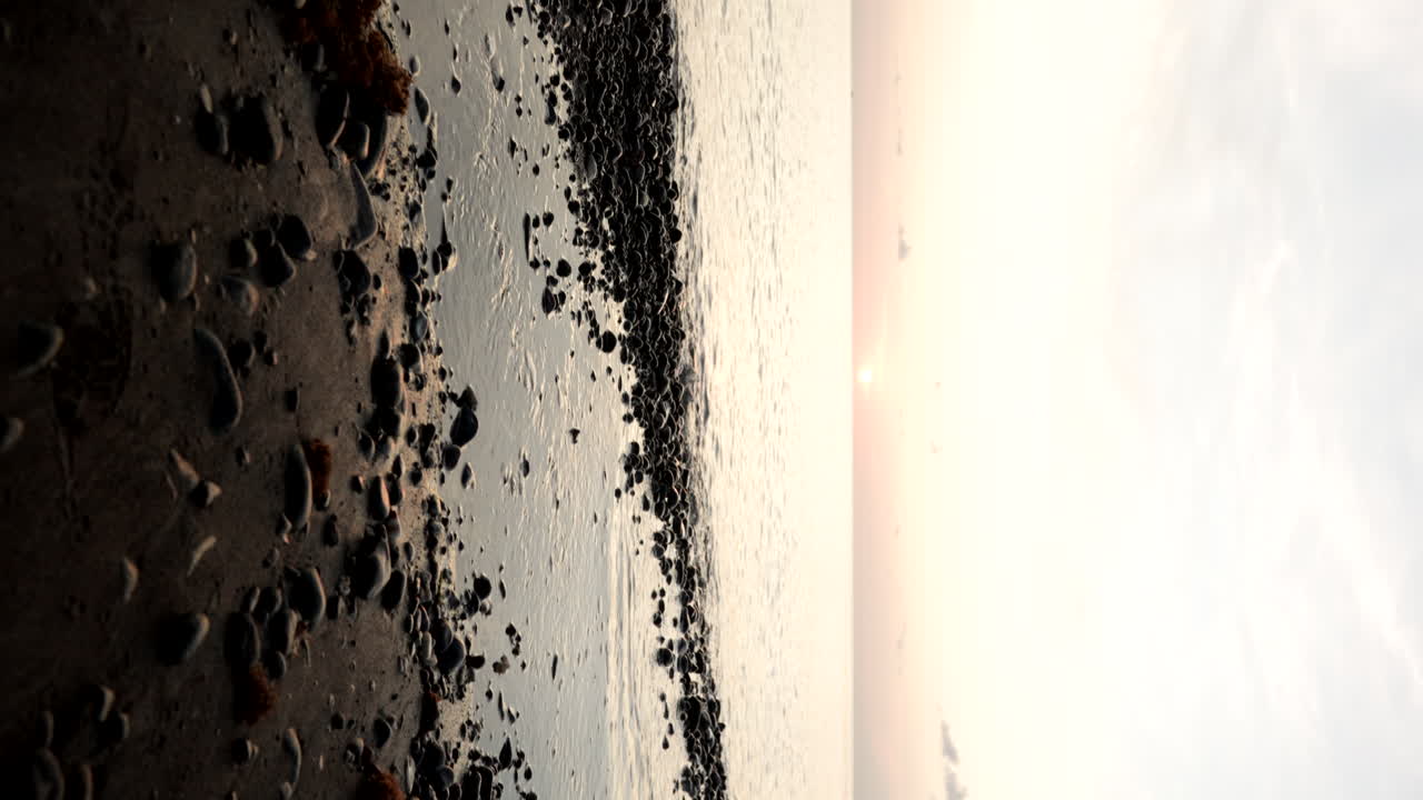 Beach with stones at sunset