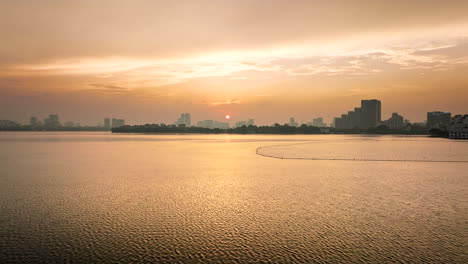 scenic view of west lake at sunset in vietnam - aerial drone shot