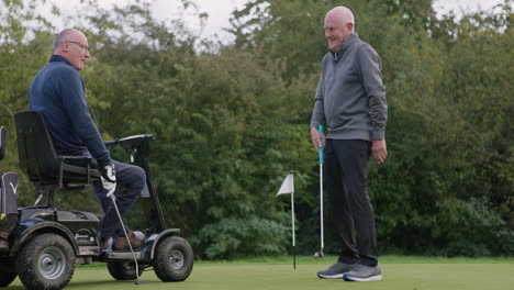 two elderly men playing golf