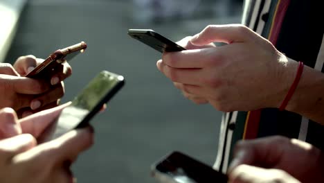 closeup view of young people using smartphones.