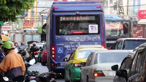 motorcycles and buses in a crowded street