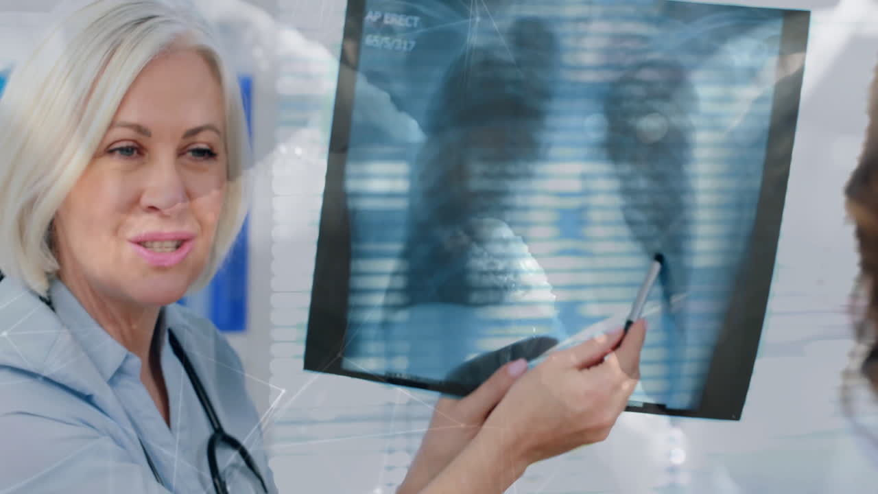 Analyzing X-ray, medical professional with patient, digital animation overlaying data