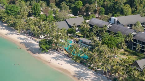 drone perspective of white sand beach village, koh chang. sunny morning aerials of thailand's coastal beauty on the island of koh chang
