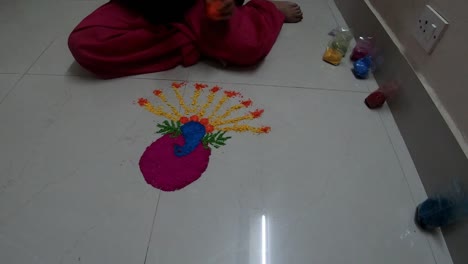 rangoli colorful making at home by young indian girl