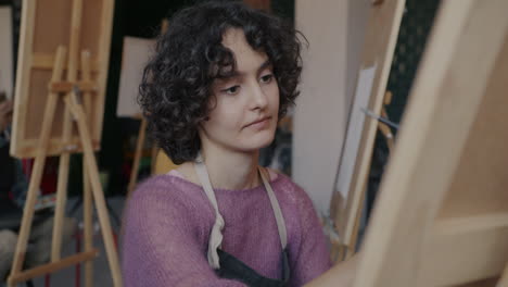 woman painting in art class