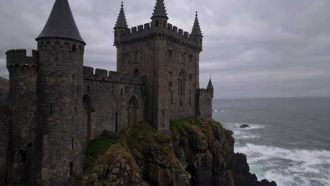 medieval castle on a cliffside overlooking the ocean