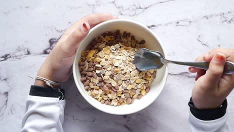 child holding a bowl of muslli on tiles background ,